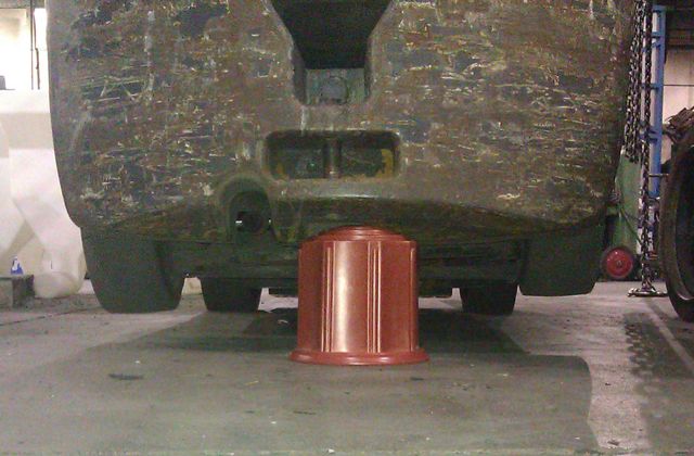 A TCM forklift rests on a plastic cremation urn in a durability demonstration.