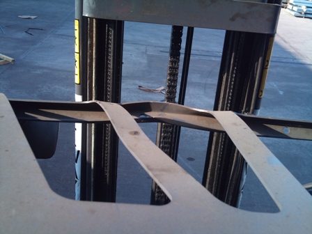 The experienced forklift engineer identified visible damage to the forklift's overhead guard.