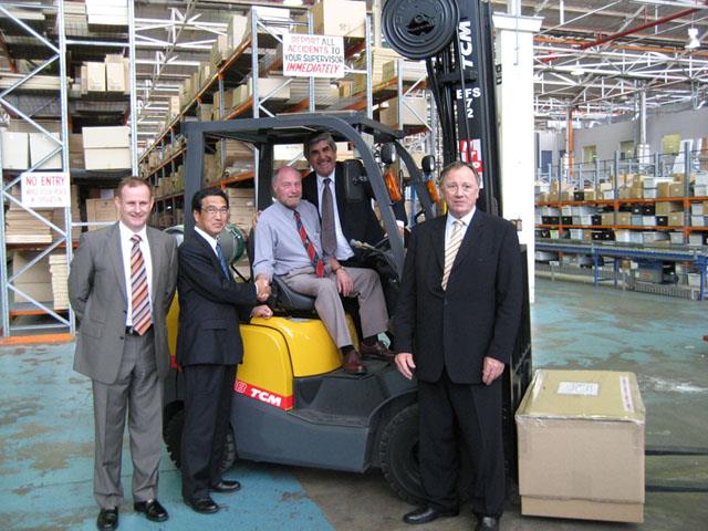 NTP's Damien Garvey (left), Nick Perdelis (behind) and John Naffine (right) together with Mr. Ishiki of the TCM Corporation and Chris Chilcott (seated) from Electrolux with the 5,000th TCM unit.