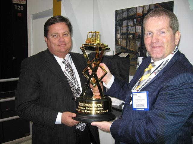 John Sneddon presenting the Golden Gabelstapler award to one of its highest selling dealers. JM Equipment president Audie Burgan receives the award at ProMat 2007 in Chicago.