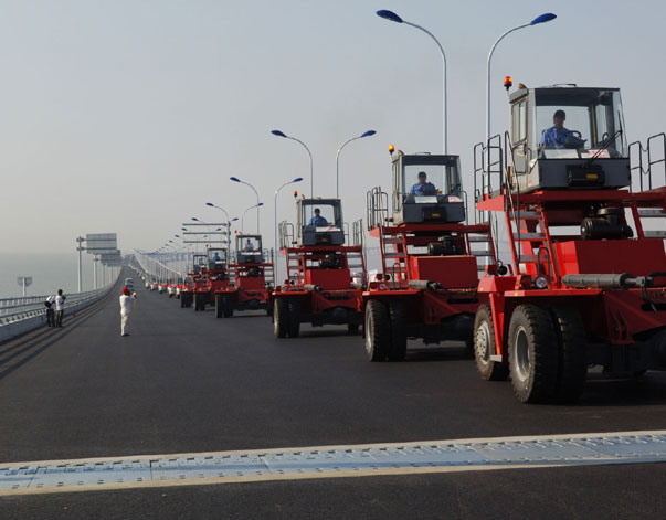 A convoy of Kalmar empty container handling forklifts and terminal tractors bound for the Yangshan Deepwater Port Phase.
