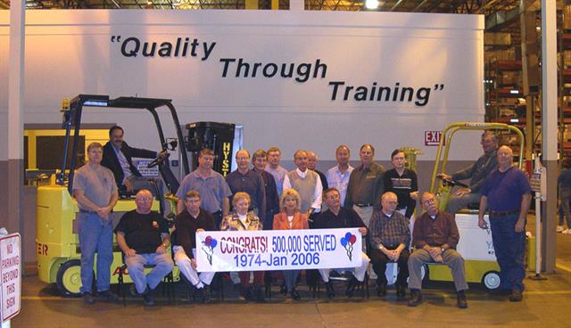Hyster president Paul Laroia (left) in the Hyster E80AC and Yale president Don Chance (right) in the first truck produced in Greenville, the Yale K58.