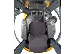 A bird's eye view of the rotating cabin. The left armrest folds down to enable the driver to exit the cabin. When exiting, the cabin is rotated 45 degrees so the door is positioned towards the step.