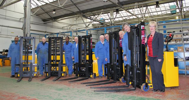 Teresa Hands (right) and Wilmat staff with the last batch of trucks to be completed for the client.