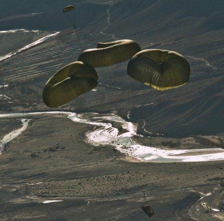 Three deployed parachutes' slow descent of forklift in Afghanistan. <br />Air Force photo by Jeffrey Allen