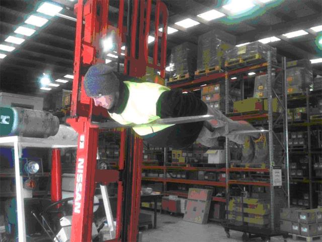 Planking across the tynes of a forklift about four metres above the ground cost him his job.