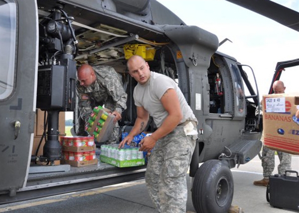 New York Army National Guard aviation soldiers Sgt. Larry Sloan, left, and Sgt. Jason Dolan, centre, a load food into a UH-60 Black Hawk helicopter as part of state emergency response efforts in the wake of Hurricane Irene. <br />PHOTO: US Dept of Defense