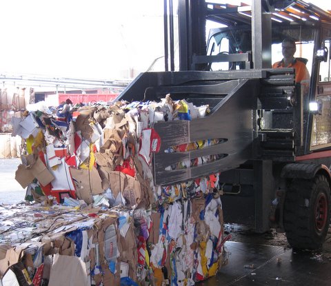 The new Cascade clamp moves a bale of recycled material.