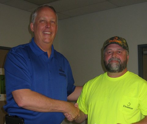 Mill manager Bob Grygotis (left) with rodeo champion Randy Norwood.