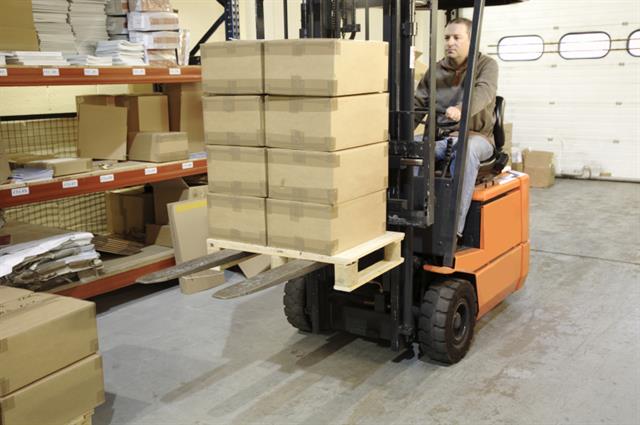 Image 1: The forklift driver in this image might not be aware that the forks protrude at the rear of the pallet, this ignorance can cause damage to goods, pallets and personnel. (see image 2). <br />(source: National Irish Safety Organisation)