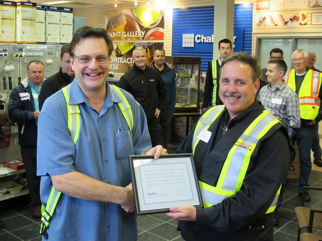 CMHDS president Dan Beers (right) presents an acknowledgement certificate to Chalifour's Grant Harris.