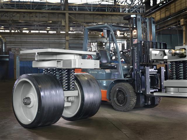 Toyota model 8FGU30 forklift assists in moving caster.