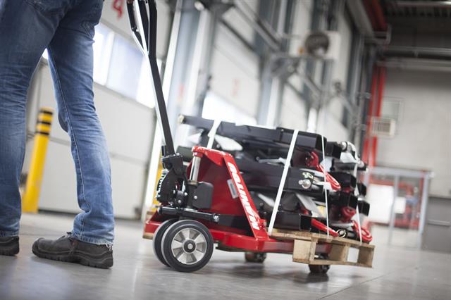 The hand pallet truck should be pulled with one hand while the operator faces the direction of travel, to ensure visibility and control are maintained.