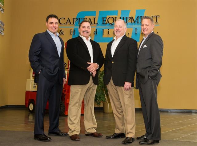 (Left to right) UniCarriers' Anthony Salgado, Capital's Jerry Ziglinski and Gary Hansen and James Radous from UniCarriers at the close of the sale in Hartland, Wisconsin.