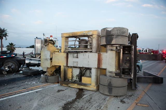 A large forklift lies on its side after one person was killed and seven others were injured after a multi-vehicle accident. PHOTO: KEVIN WARN, OCR