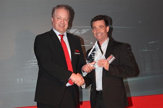 Carrylift managing director Steve Routledge, right, receives his award from TCM's Thomas Wiklund.