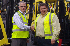 Gough Materials Handling GM Darren Allen (left) with Greg Miller, Toll NZ Group general manager.