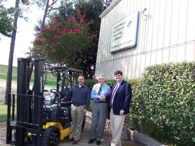 SWMHCo senior VP Kenn Harper and owner and president Joe Harper with Komatsu's Patrick King.