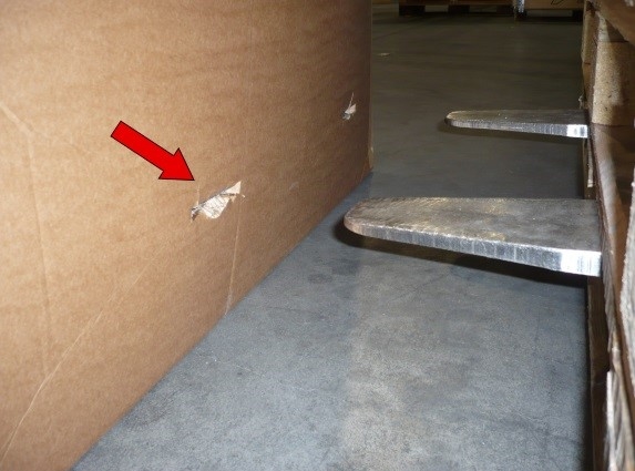 Damage caused because the lift truck forks protrude at the rear of the forklift.