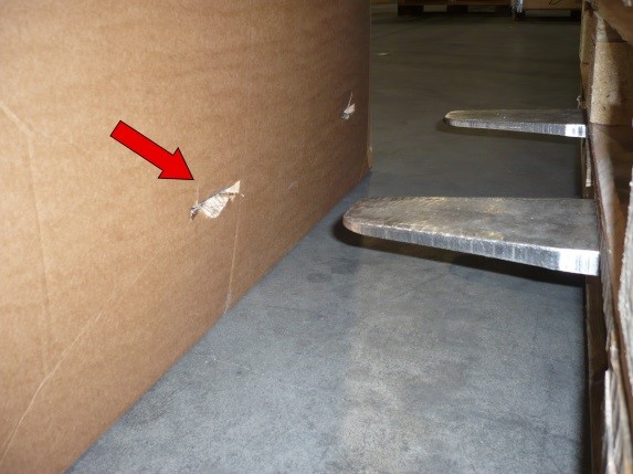 Damage caused because the lift truck forks protrude at the rear of the forklift