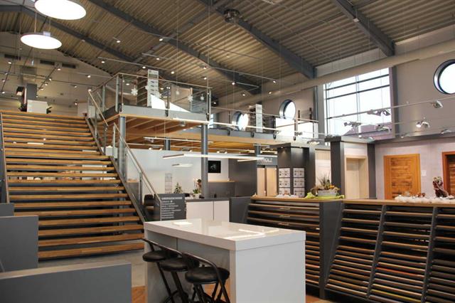 Order pickers retrieving materials from high shelves.