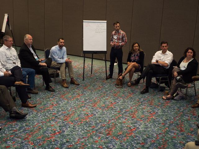 Ernie Elbert, an industrial engineer with Dillard's department stores and conference planning committee volunteer, leads a discussion group at the annual conference