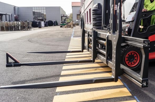 A third fork tine and a slip-on type load securing device provide additional security