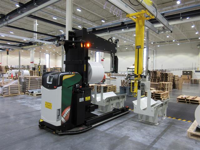 Rocla Probe-AGV placing rolls on a stand for later packaging of customer pallets.