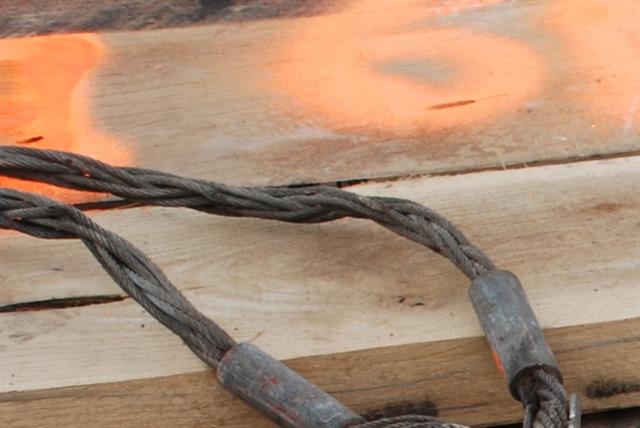 A safety cable hooked to an eyehole at the top of the attachment.