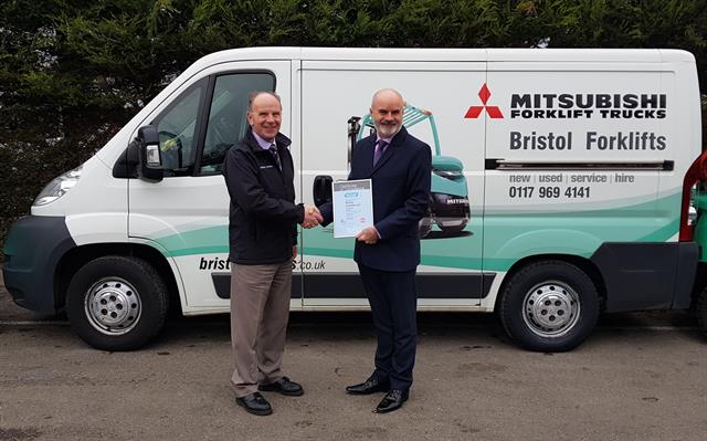 FLTA quality manager Lee Medway presents the audit compliance certificate to Ian Mounce, general manager of Bristol Forklifts.