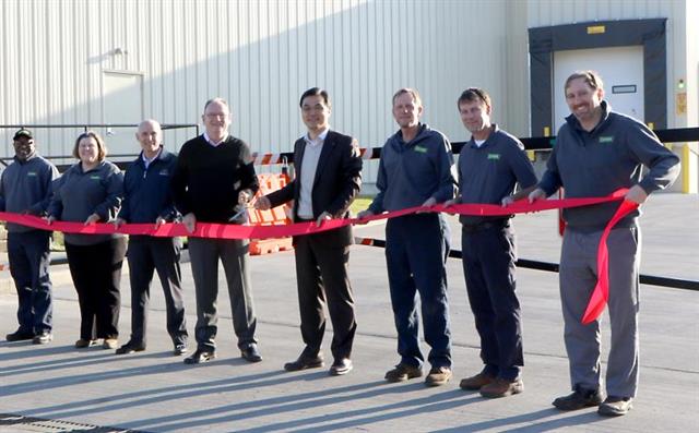 Dennis Lawrence and SS Baik open the new facility in the presence of several other Clark team members
