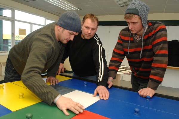 Andrew Rice (centre) is pictured completing one of the team building exercises with colleagues Blair Jebson (left) and Jeff Pegg (right).