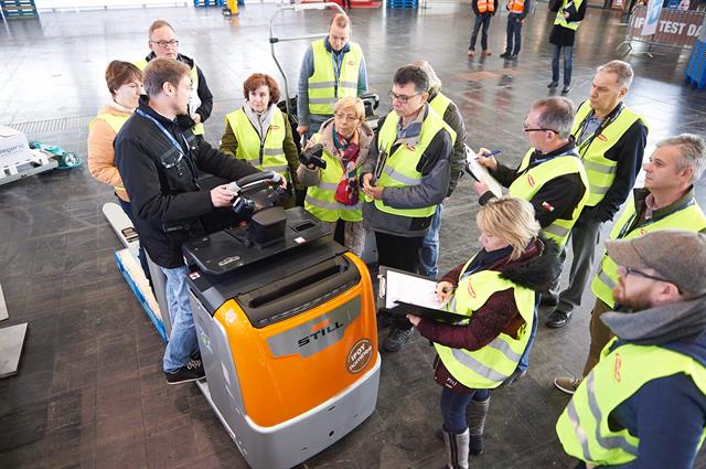 Jury members inspect a finalist
