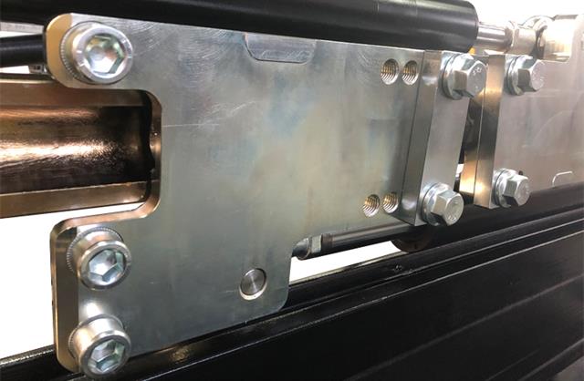 View of the fork carriers, to fit standard lift truck forks. These are actuated by two hydraulic cylinders, sliding on a tropicalized guide.