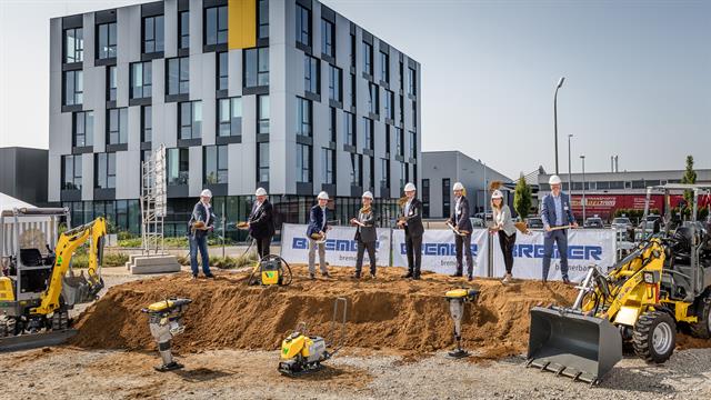 Jungheinrich and Wacker Neuson officials turn the first sod in the presence of the construction team