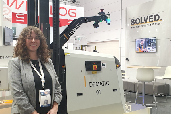 Cara Skelsey, Marcoms Manager in Asia Pacific for Dematic, shows off one of their AGVs.