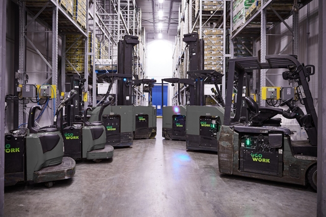 Fleet of pallet-jack riders and reach trucks equipped with UgoWork lithium-ion batteries in a fresh food warehouse