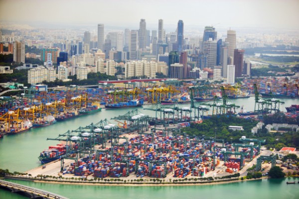 PSA Brani Terminal and behind it, PSA Keppel Terminal, set against the skyline of Singapore's central business district.