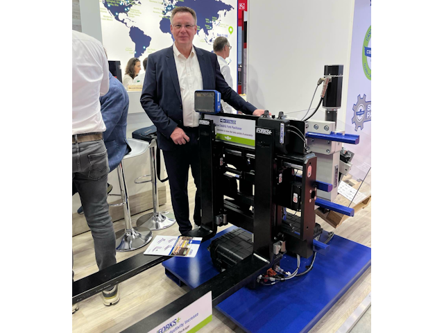 Udo Schmidt, Vice President - Europe, stands proud next one of their new Electrix™ Fork Positioners.
