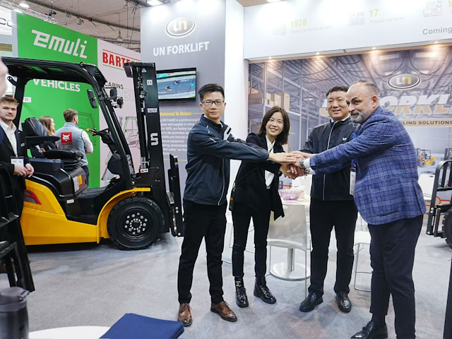 At the UN Forklift stand Jack Yang, vice president of sales, Serena Wu, vice president, and Edward Cheng, sales manager, enjoy a conversation with a prospective customer.