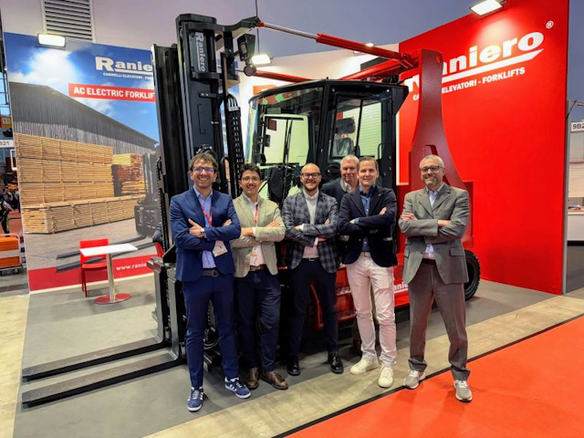 Standing in front of one of their AC Electric Forklifts, a winning photo of the Raniero team.
