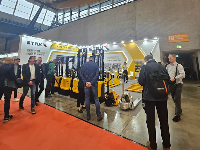 A collection of LogiMAT visitors inspect the STAXX range of  powered pallet truck and electric pallet stacker products.