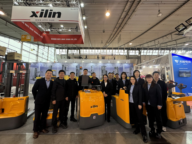 The Xilin team gathers around a collection of their finest materials handling offerings.