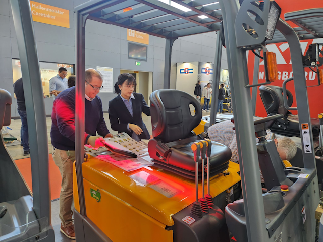 A couple of visitors scope out one of Xilin's Li-ion forklifts, the company has a wide range of electric warehouse equipment on display.