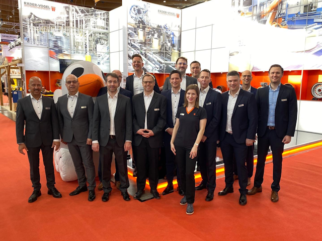 The RÄDER-VOGEL team, including their fine feathered friend in the background, smile for the camera.