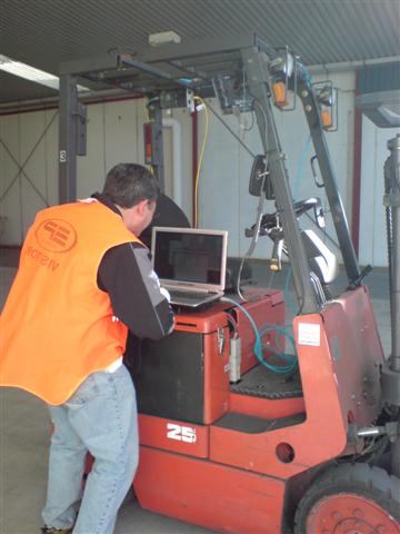 A technician programming up a Peacock solution on a forklift