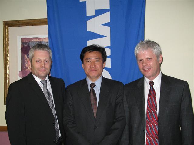 Caption: Eiji Fukuda (centre), General Manager of Komatsu Forklift Europe, welcomes Andrew (left) and Trevor De'Ath (right) of Ambassador as their new distributor in the UK.