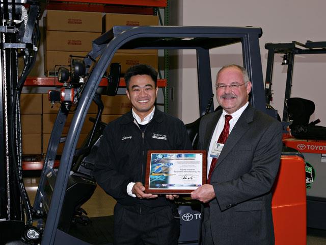 Sonny Toyoda, president of TIEM, receiving honours from Rick Bossingham, assistant commissioner of the Indiana Department of Environmental Management.