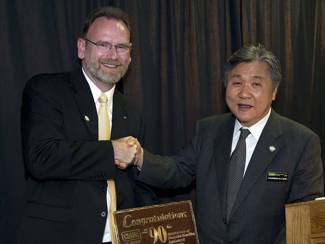 Dennis Lawrence shakes SH Baik's hand during Clark's 90th anniversary celebrations in May 2007.