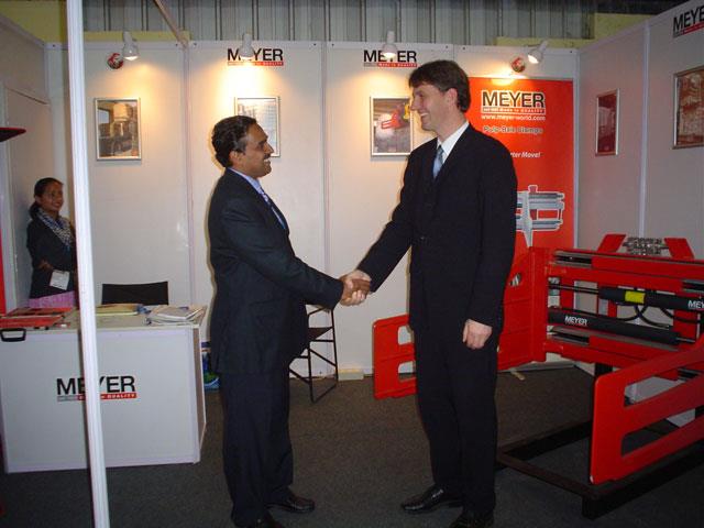 MK Vinod, Meyer India's sales manager, shaking hands with Hansjörg Freund, Meyer's export sales manager.